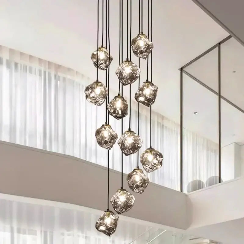 A modern decorbites led pendant light with irregular faceted glass globes hanging by black cords for indoor lighting