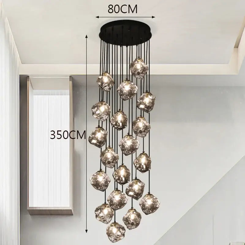 A modern DecorBites led pendant light with a black ceiling mount and faceted glass globes for staircase lighting