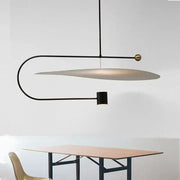 Modern black and brass decorbites led pendent fixture with curved metal frame and oval diffuser for dining room lighting