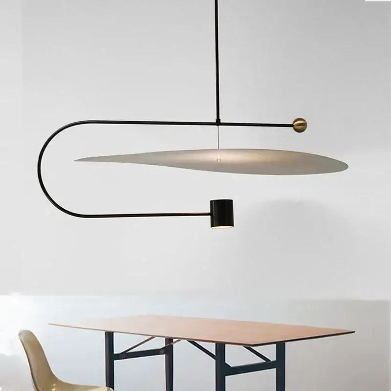 Modern black and brass decorbites led pendent fixture with curved metal frame and oval diffuser for dining room lighting