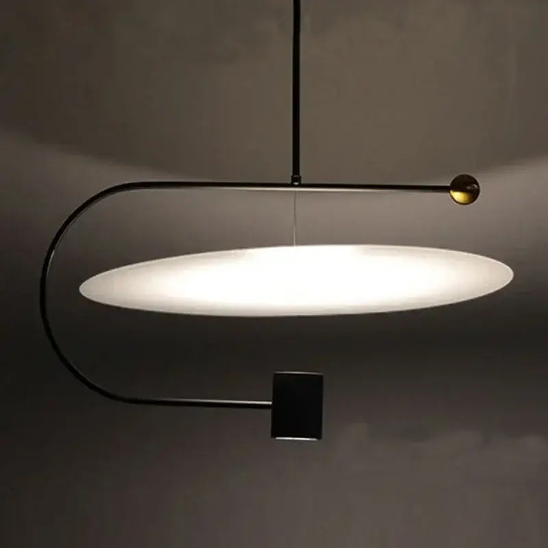 DecorBites™ modern minimalist pendant light fixture with black metal frame, frosted glass shade, and brass accent for indoor use