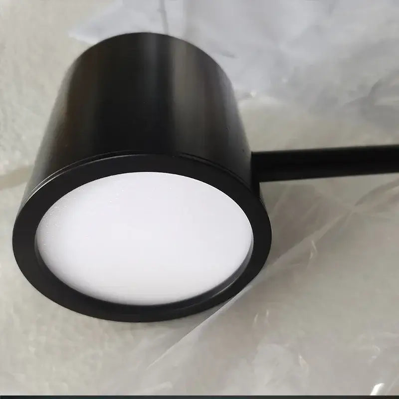 Black cylindrical DecorBites LED pendant light fixture with matte finish and white diffuser for dining table and kitchen island