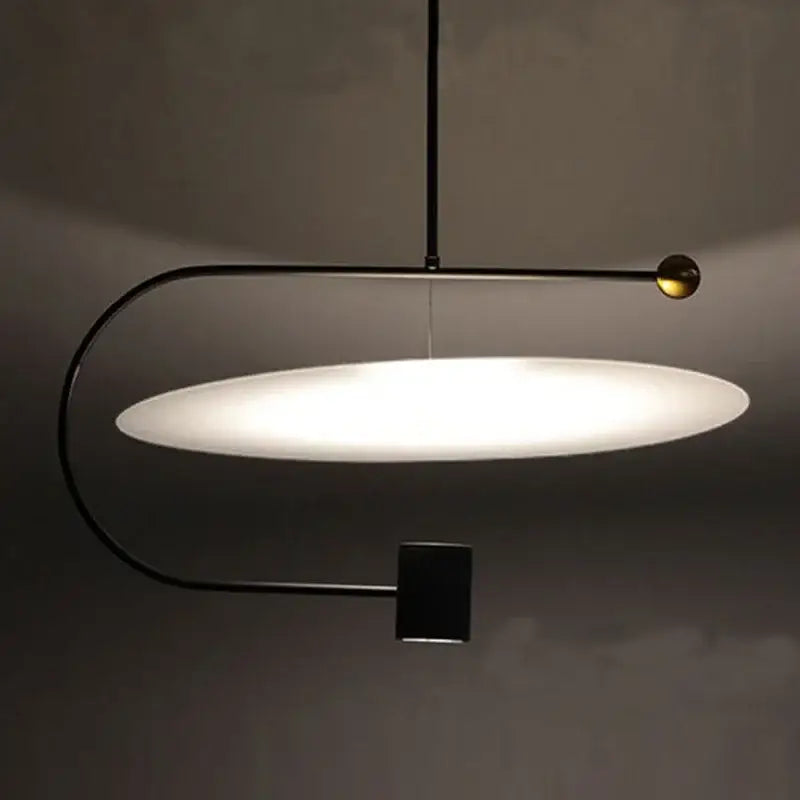 Modern black metal pendant light with glowing white oval glass shade and gold accent by decorbites led light fixture