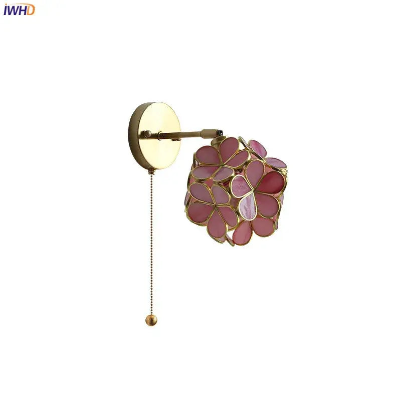 A delicate pink floral decorbites led petal wall sconce with brass finish and beaded pull chain for modern lighting