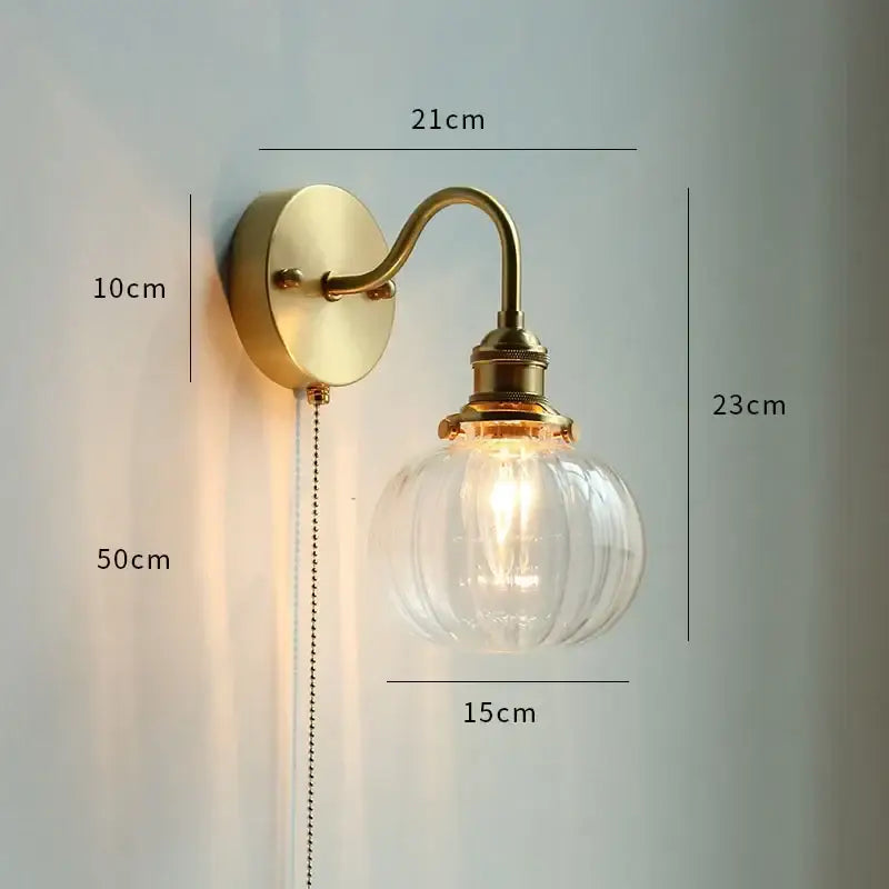 Brass-finished DecorBites LED Petal wall sconce with clear ribbed glass globe and exposed filament bulb for modern decor