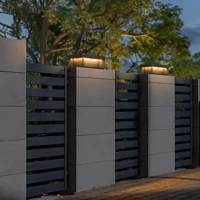 Modern rectangular decorbites led pillar top courtyard lights with warm led illumination on gray concrete pillars