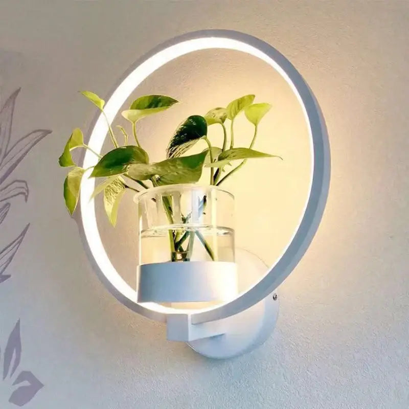 Modern DecorBites™ led plant wall lamps with circular white LED ring and clear glass vase holding green leafy plant