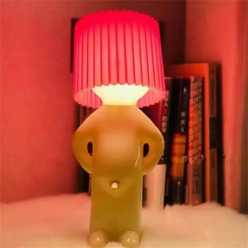 A whimsical translucent yellow elephant-shaped decorbites led pleats table lamp with a vibrant red shade for kids gift