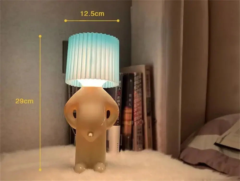 A charming beige elephant-shaped decorbites led pleats table lamp with a pleated gradient blue and white shade for reading