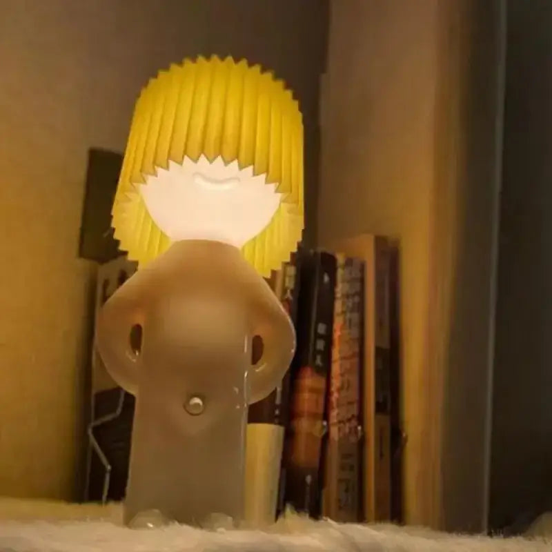 Translucent beige decorbites led pleats table lamp with bright yellow hair and closed eyes ideal for bedroom night light