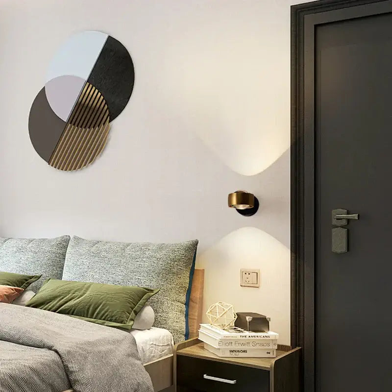 Modern circular decorbites led projection wall lamp featuring geometric black and gold slats with pastel hues for living room use