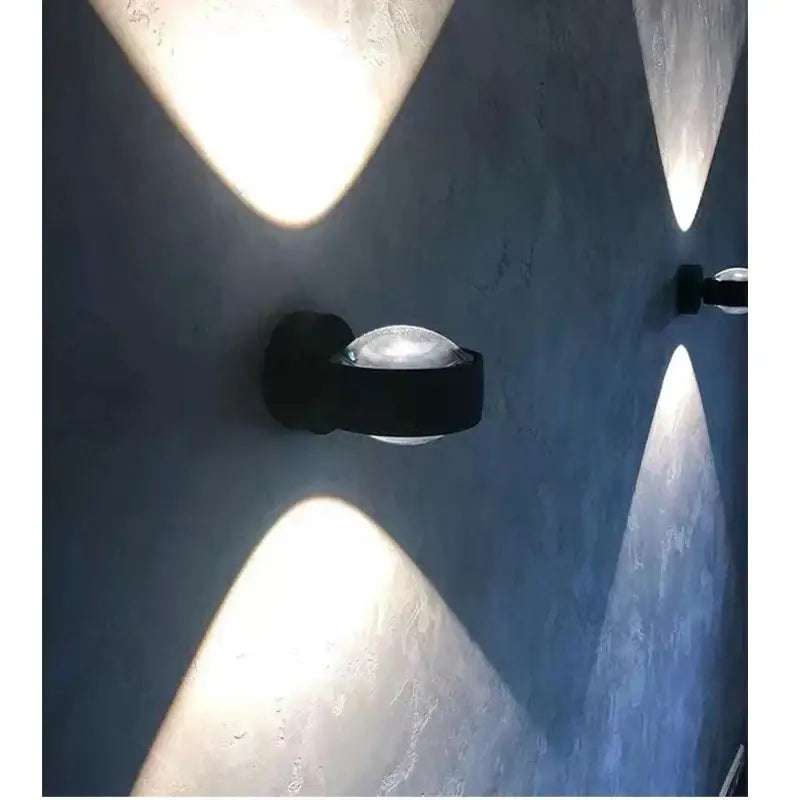 Black DecorBites LED projection wall sconce with frosted glass diffuser casting soft geometric light patterns
