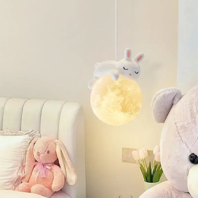 DecorBites led rabbit chandelier pendant light featuring a soft white plush rabbit on a glowing golden-yellow moon lamp