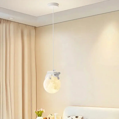 Soft glowing gray bear pendant light hugging a moon by decorbites led rabbit chandelier for living room decor