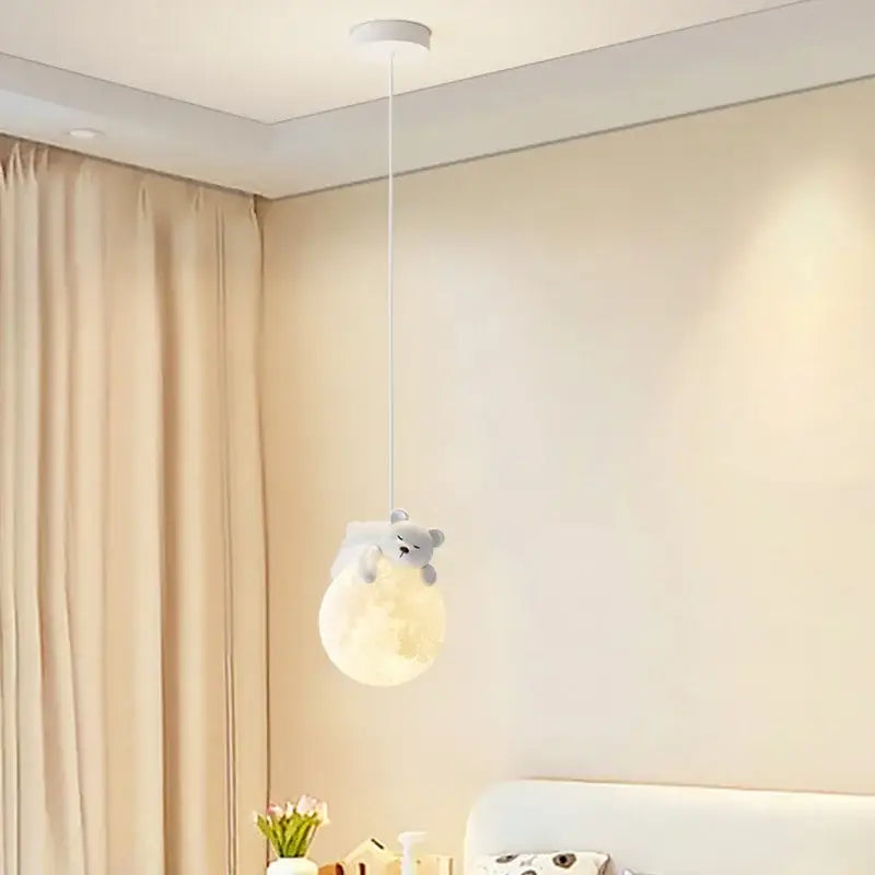 Soft glowing gray bear pendant light hugging a moon by decorbites led rabbit chandelier for living room decor