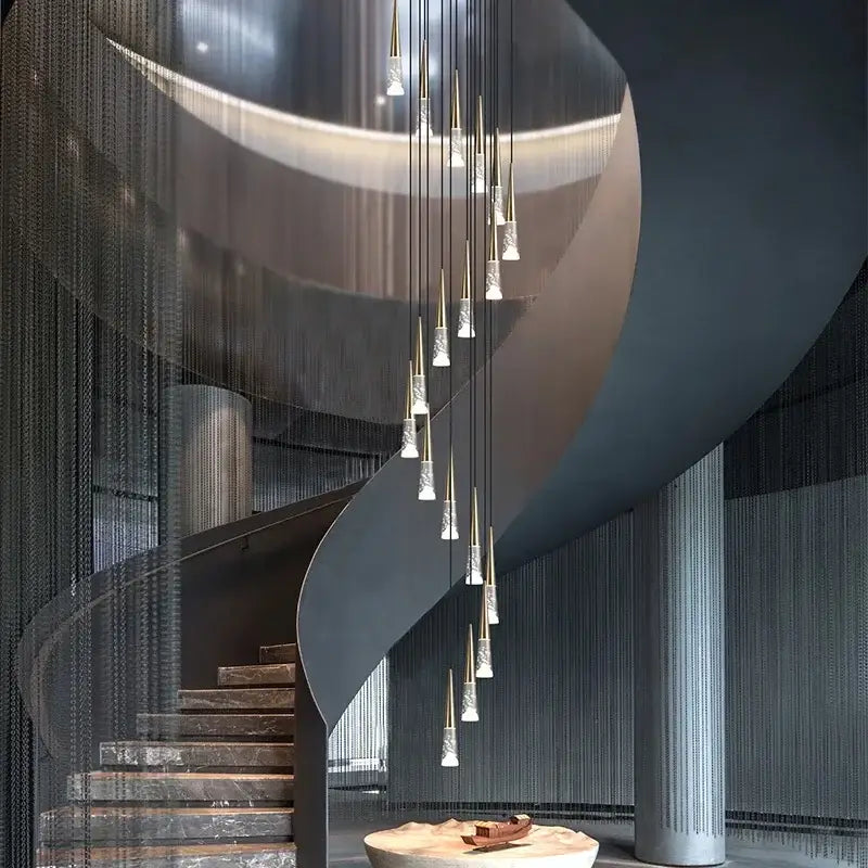 A modern decorbites led rain drop chandelier with gold-toned rods and clear glass pendants for staircase lighting