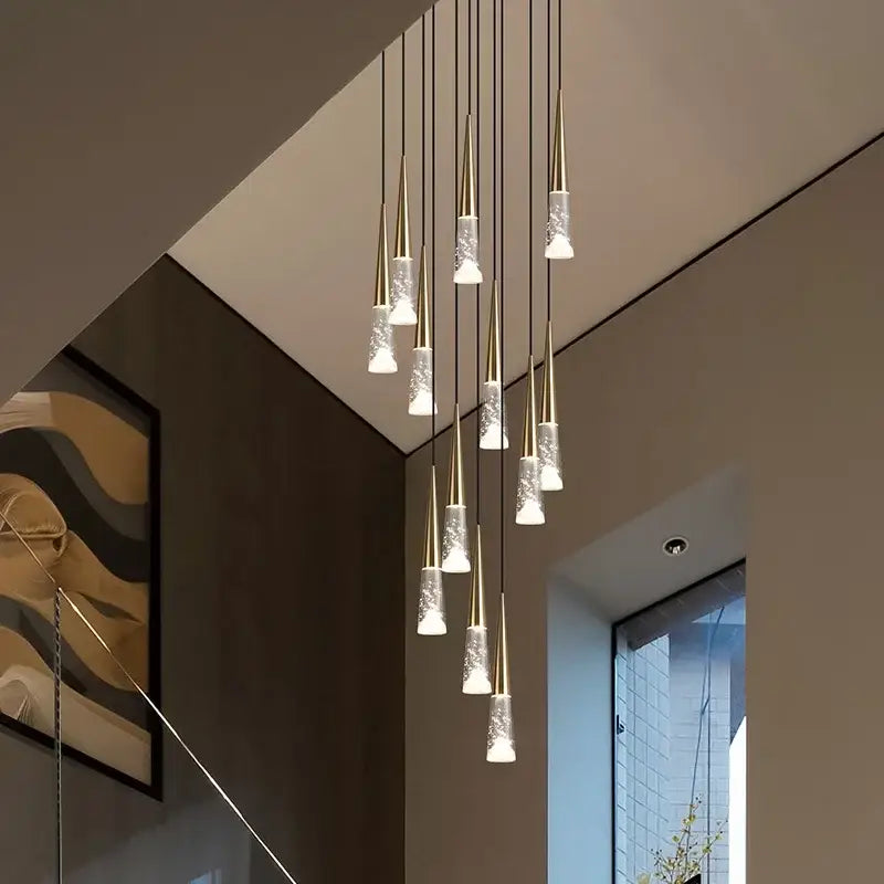 Modern gold-toned decorbites led rain drop chandelier with frosted glass shades cascading for staircase lighting