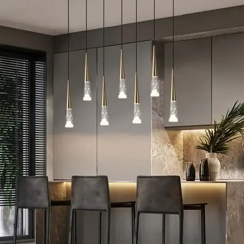 Modern pendant light decorbites led rain drop chandelier with gold metal tops and clear textured glass shades above island