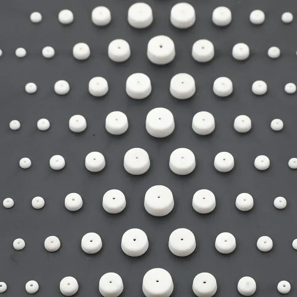White ceramic beads arranged in a grid pattern complement the decorbites™ led rain shower set with digital display and bidet mixer faucet