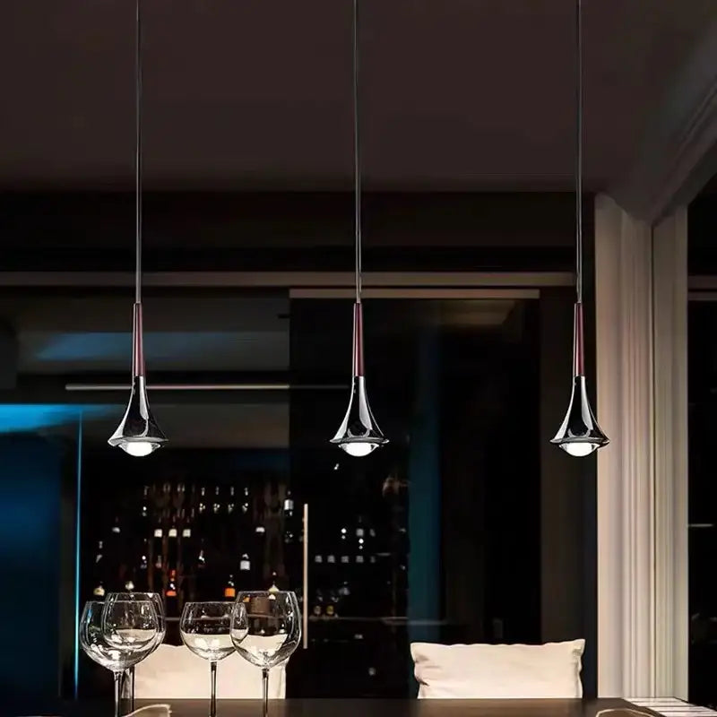 Three chrome conical pendant lights with dark cords as part of decorbites led rain staircase chandelier for indoor use