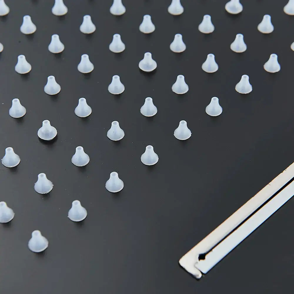 Transparent silicone earbud tips displayed on dark surface alongside decorbites™ rain waterfall shower head with remote control