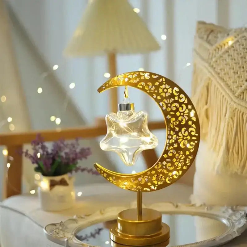 Golden crescent moon table lamp with intricate cut-out patterns holding a glowing star decorbites led ramadan moon
