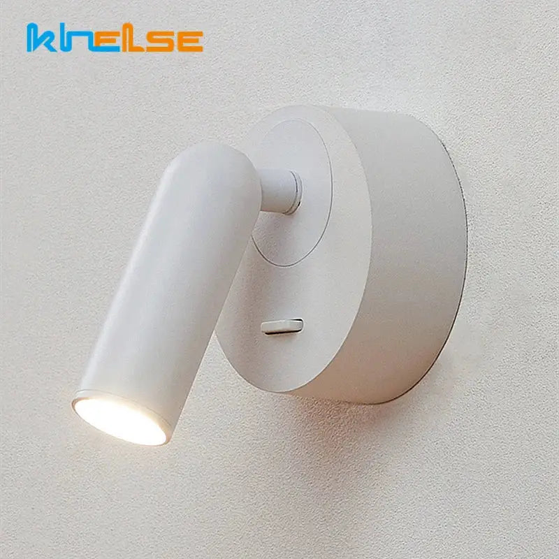 White knelse decorbites led reading wall lamp with sleek cylindrical head and circular base for bedside use