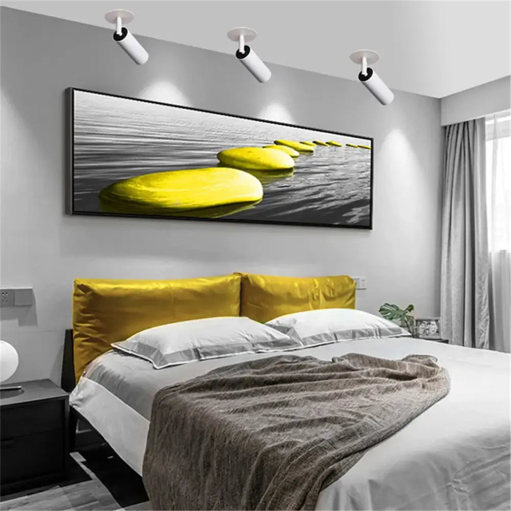 A modern black-framed canvas print with vibrant yellow stones complements decorbites led recessed ceiling lights for kitchen use