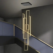 Modern geometric decorbites led rectangle chandelier with glowing gold strips suspended from black ceiling fixture for staircase