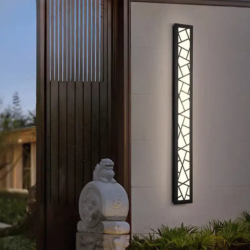 Modern black-framed DecorBites LED rectangle wall lamp with geometric glass panels emitting warm light 3000K for stairs