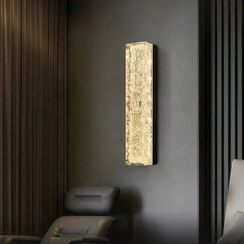A modern decorbites led resin wall lamp with textured golden glass and black frame for bedroom and living room