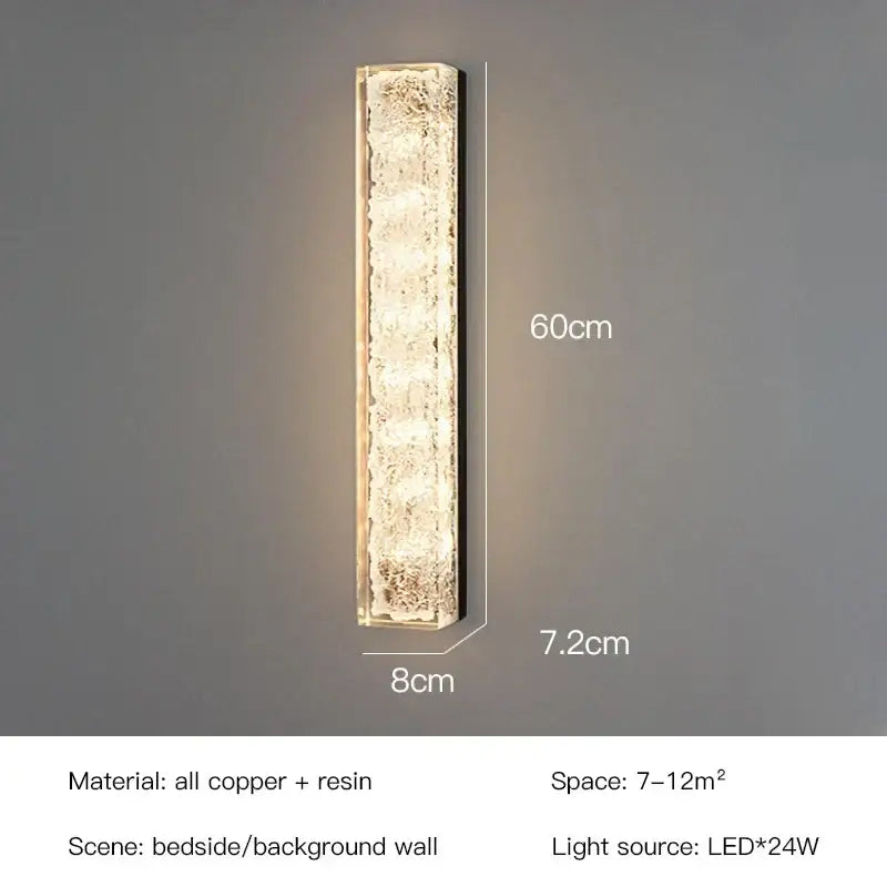 A sleek 60cm tall decorbites led resin wall lamp with textured translucent resin and copper frame emitting warm led light