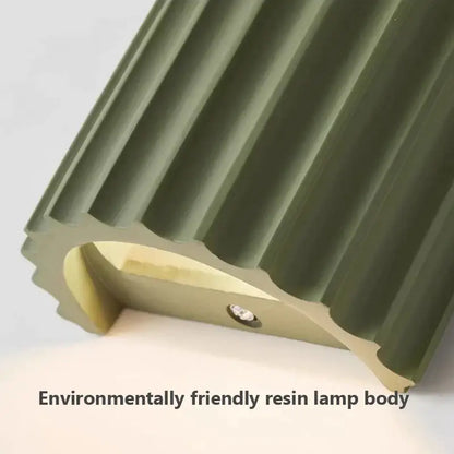 Olive green ribbed resin wall sconces with smooth curved interior and circular detail by decorbites led resin for minimalist decor