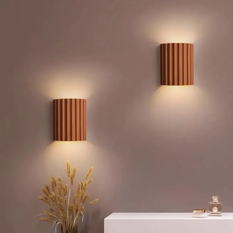Copper-colored vertically ribbed resin wall sconces with warm ambient lighting by DecorBites LED resin for entryway decor