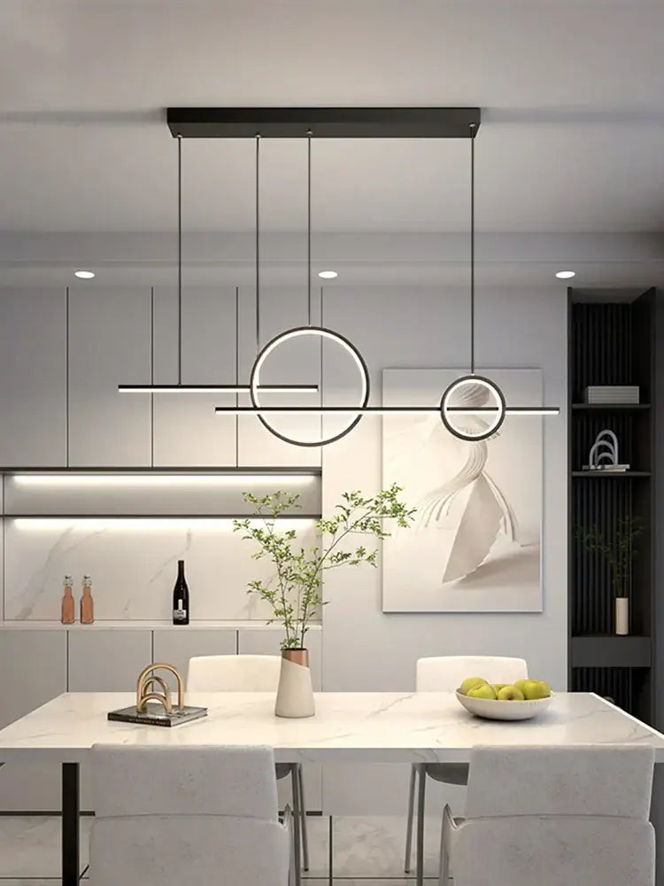 Modern black minimalist decorbites led restaurant chandelier with circular linear led elements above white marble dining table