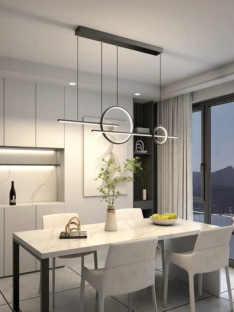 Modern black minimalist decorbites led restaurant chandelier with circular and linear led elements above dining table