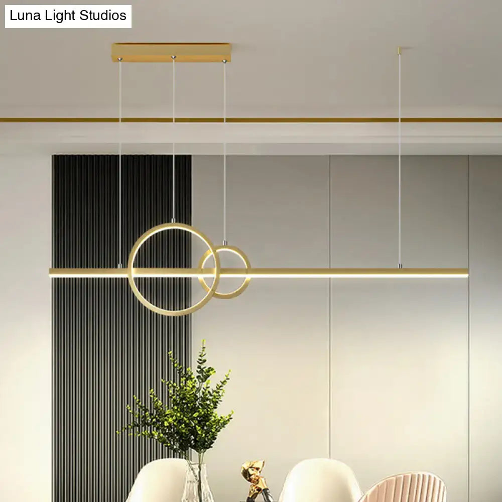 Modern gold-toned led restaurant island pendant with sleek circular rings and warm white lighting by DecorBites