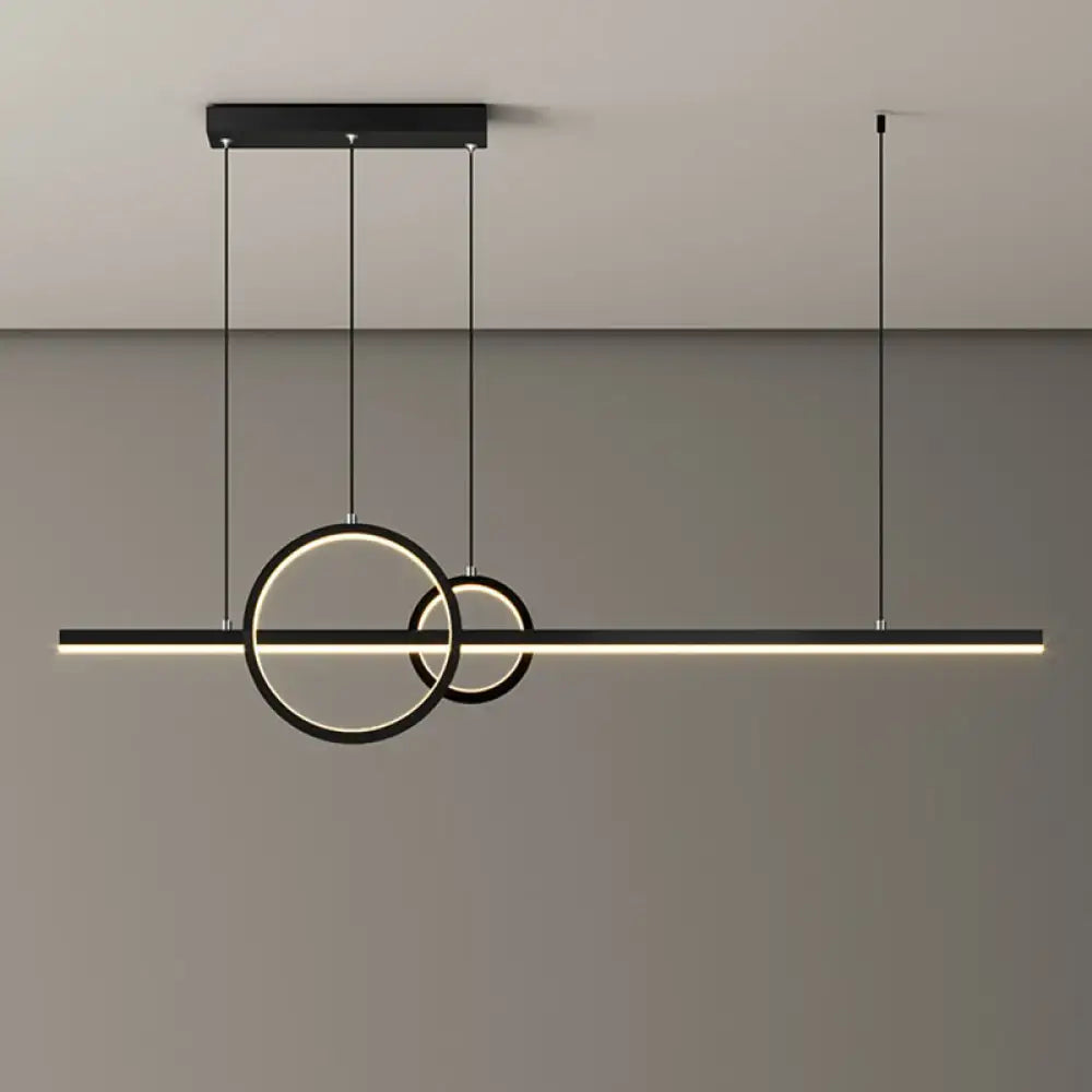 Modern black and gold metal led restaurant island pendant with two warm white glowing circular rings suspended