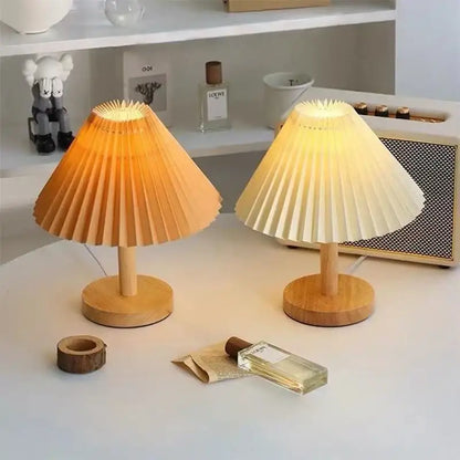 Two warm-toned pleated paper lampshades with wooden bases in decorbites led retro table lamp for interior lighting