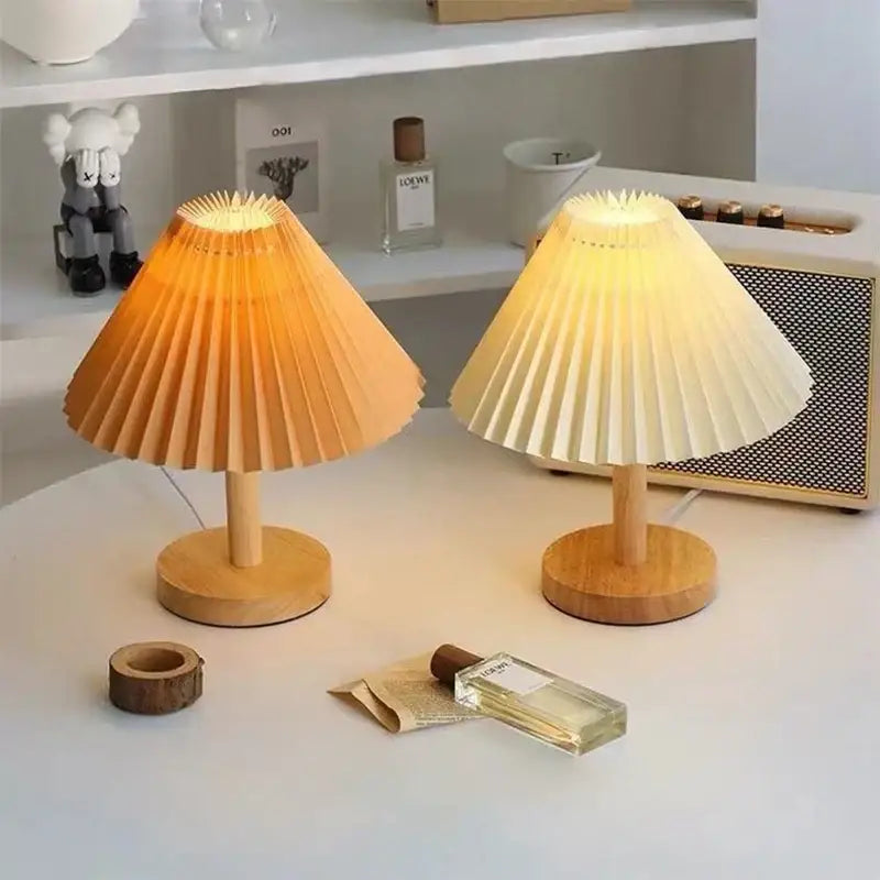 Two warm-toned pleated paper lampshades with wooden bases in decorbites led retro table lamp for interior lighting