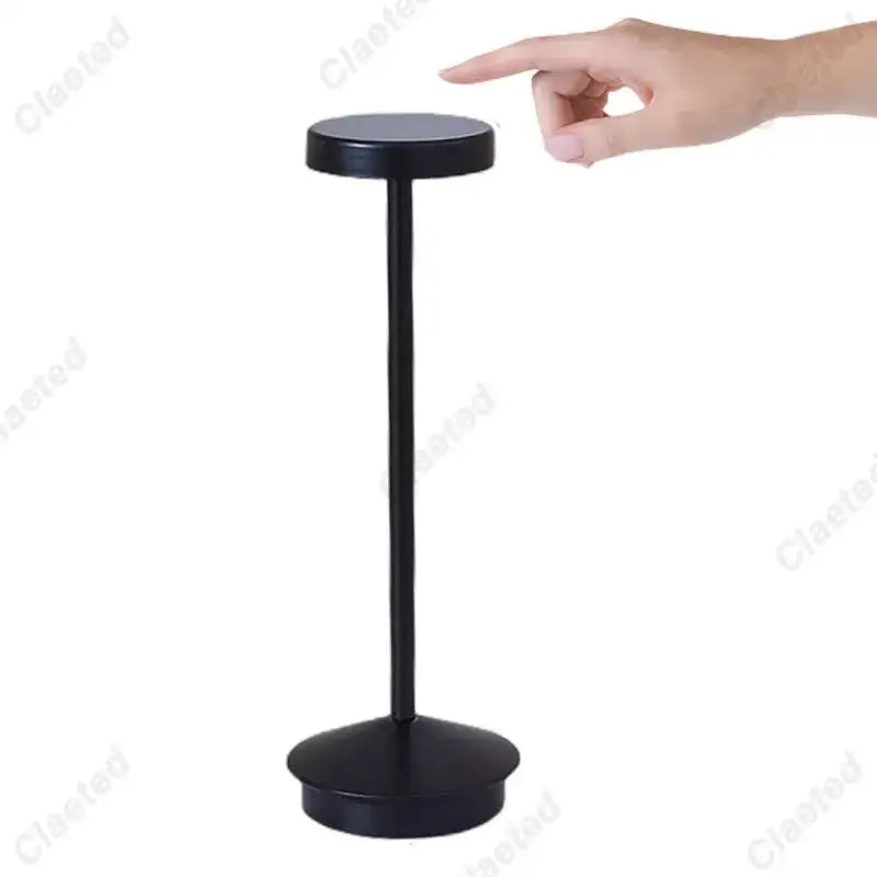 Black matte finished table lamp with circular top and base and slender column for decorbites led retro touch use