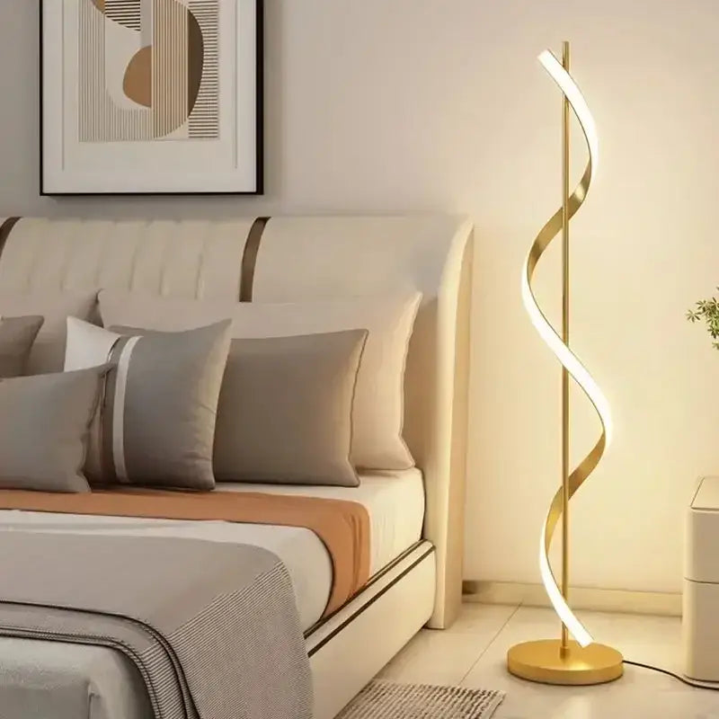 Gold-colored sleekly curved DecorBites LED Revolve floor lamp with modern spiral design and integrated LED lighting for indoor decor