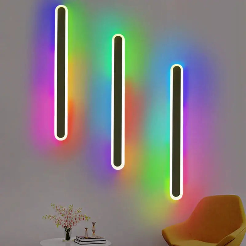 Three sleek decorbites led rgb wall lights with glowing white neon edges cast vibrant rainbow patterns indoors