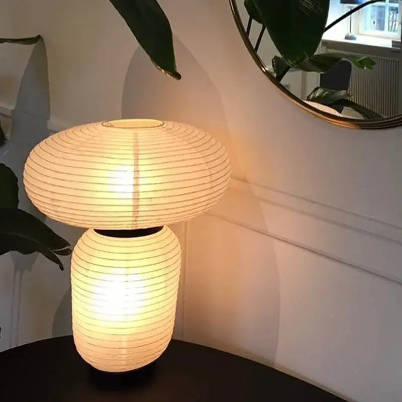 Warmly glowing mushroom-shaped DecorBites™ led rice paper table lamp with ribbed off-white minimalist design