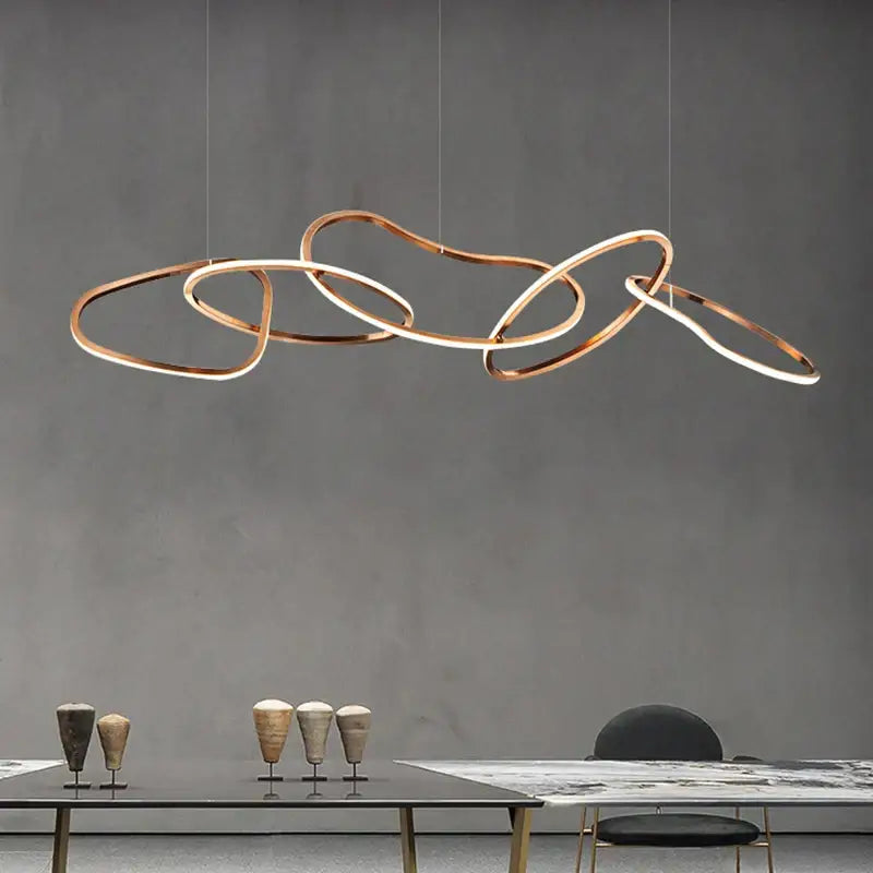 Modern copper-toned DecorBites™ LED ring chandelier with interlocking rings for living and dining room lighting