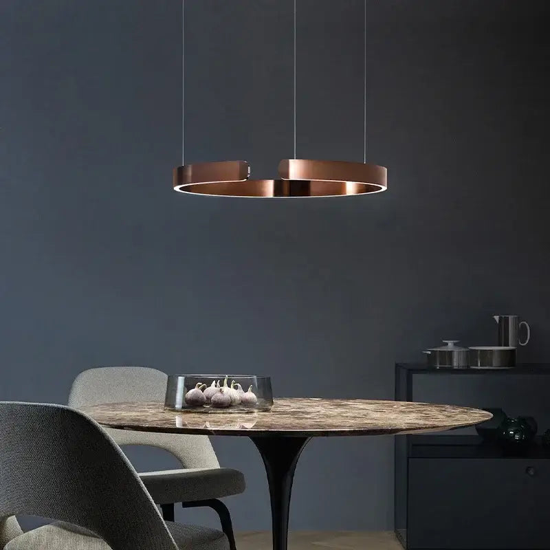 Copper-finished DecorBites™ led ring chandelier with sleek modern design hanging above dining room table lighting