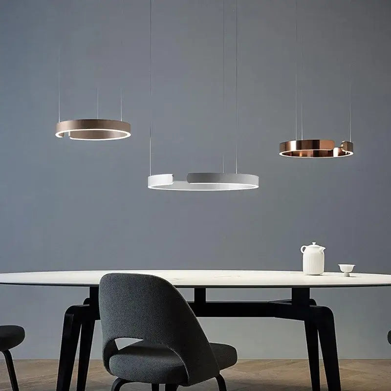 Three minimalist led ring chandelier pendant lights in brushed gold and matte white for modern dining room lighting