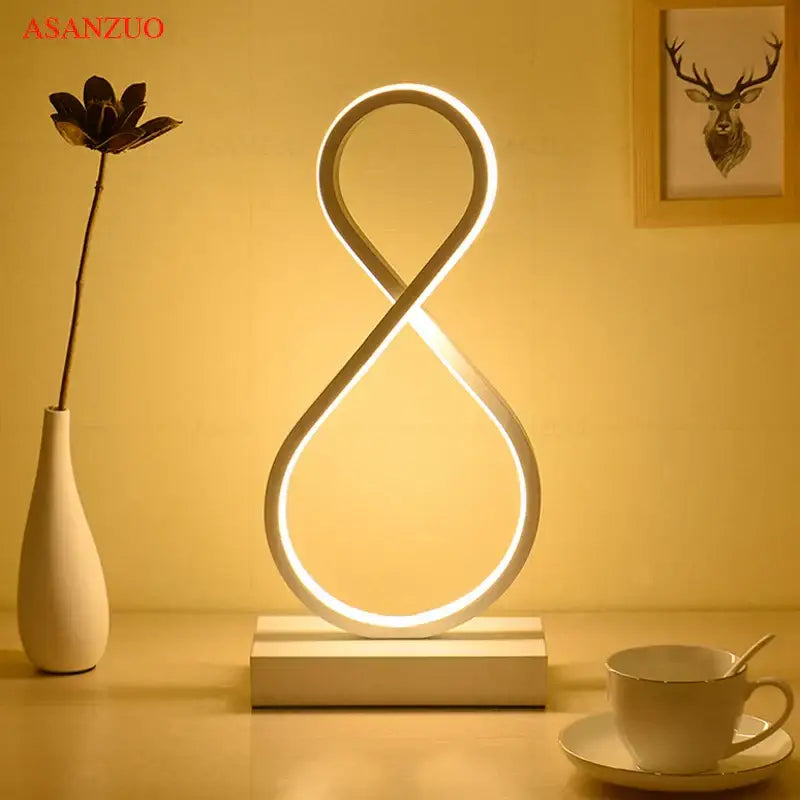 Modern nordic led ring table lamp decorbites with sleek white frame and warm glowing infinity-shaped light