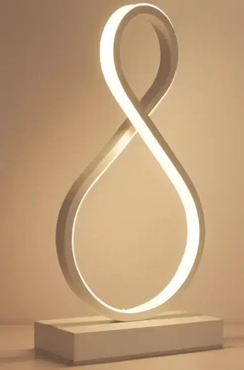 DecorBites™ led ring table lamp with a sleek white infinity-shaped frame and minimalist base for modern bedroom lighting