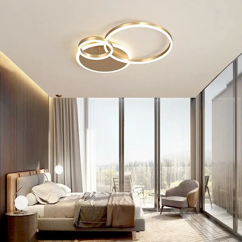 Modern gold-toned decorbites led rings ceiling chandelier with overlapping rings and integrated dimmable led lighting